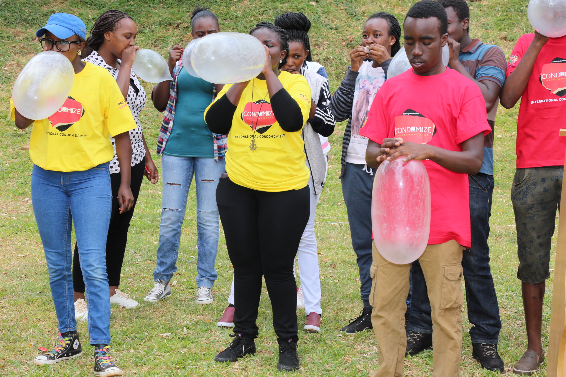 Students from various institutions of higher learning participate in a condom size testing exercise